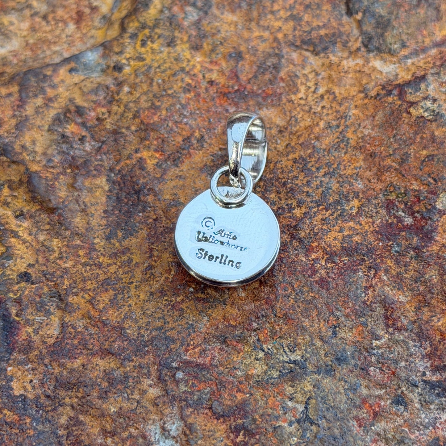  A small Pendant. A polished sterling silver dome sits nestled within a smooth shadowbox rim, creating a clean, sculptural depth in a petite, wearable form. Simple loop bail. 