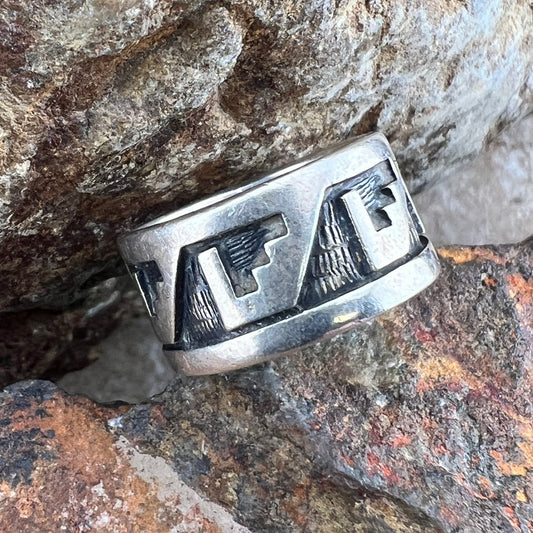 Overlayed Sterling Silver ring. Geometric Eagle--like shapes repeat themselves around the band; they are oxidized a deeper silver and textured. 