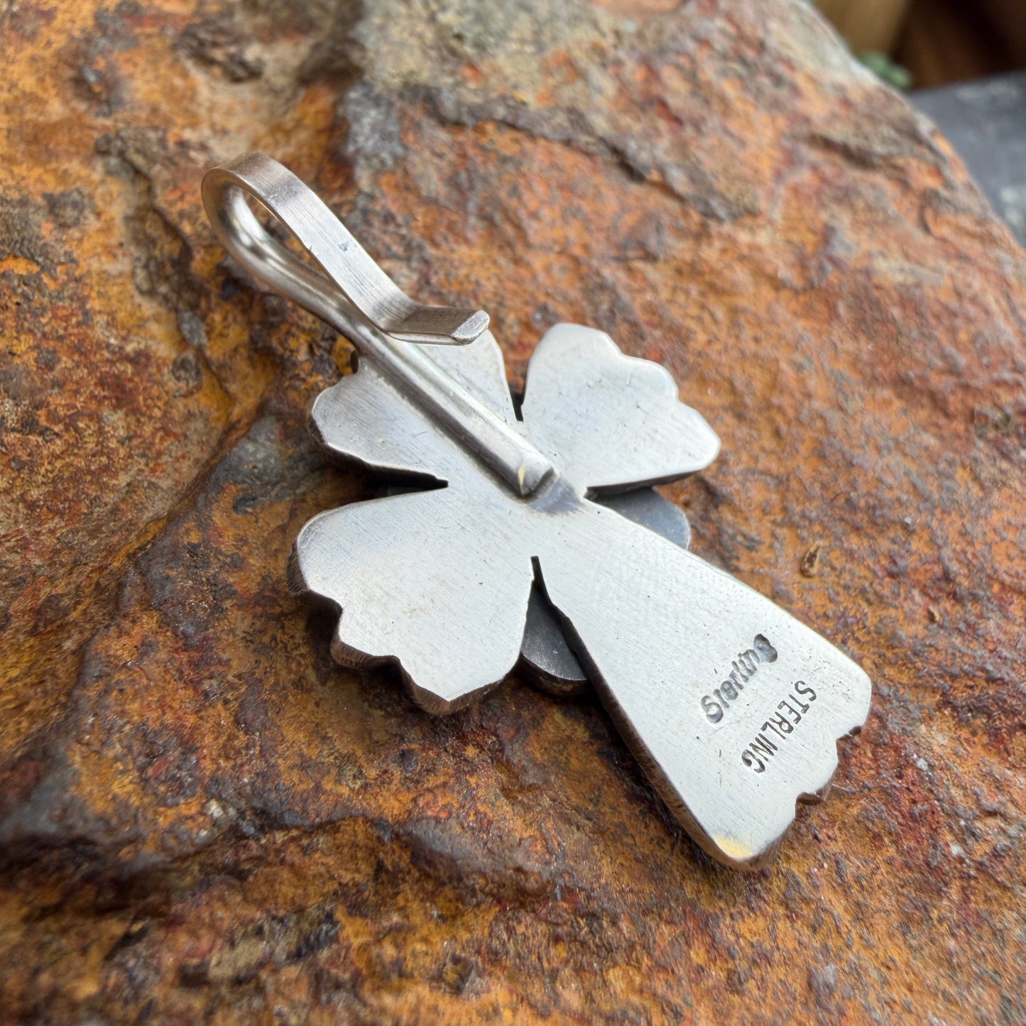  back of a Silver cross pendant  stamped "sterling" 