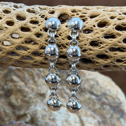 Sterling Silver Sphere and Byzantine Chain Dangle Earrings by Artie Yellowhorse - close-up on cholla cactus showing polished sphere detail and Byzantine chain links