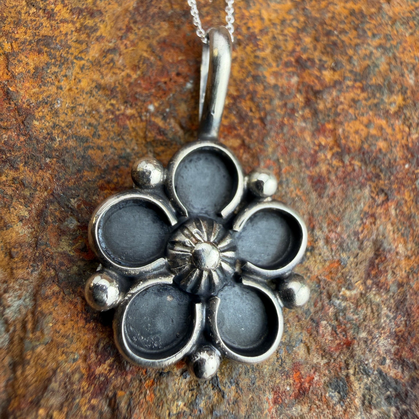 Silver floral pendant on a chain