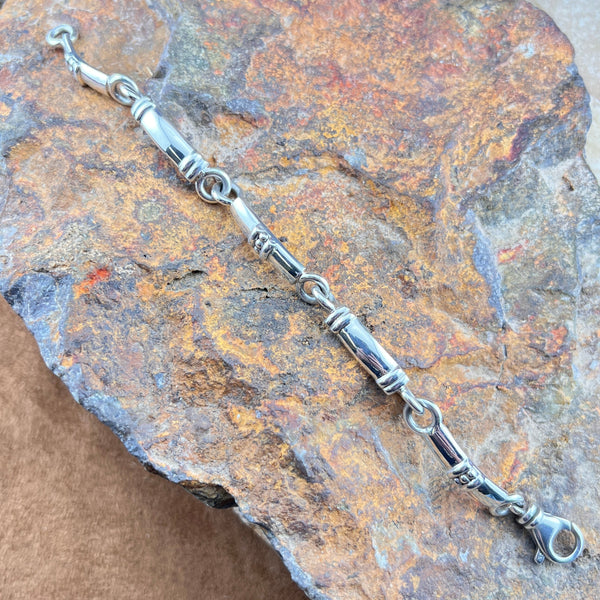 Silver bracelet on a textured stone surface