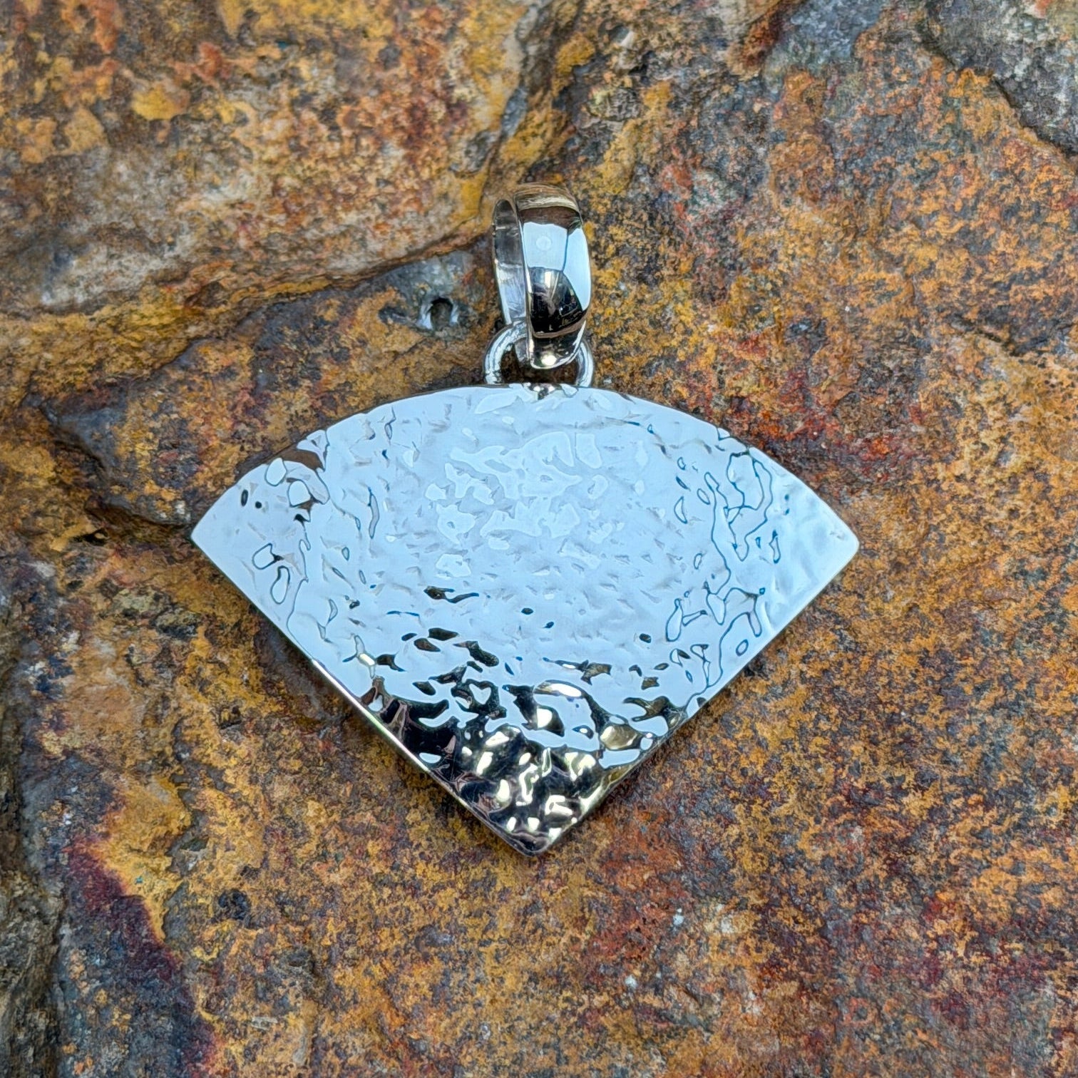 Sterling Silver Textured Fan Pendant by Artie Yellowhorse - angled view showing light-catching textured finish on fan-shaped pendant