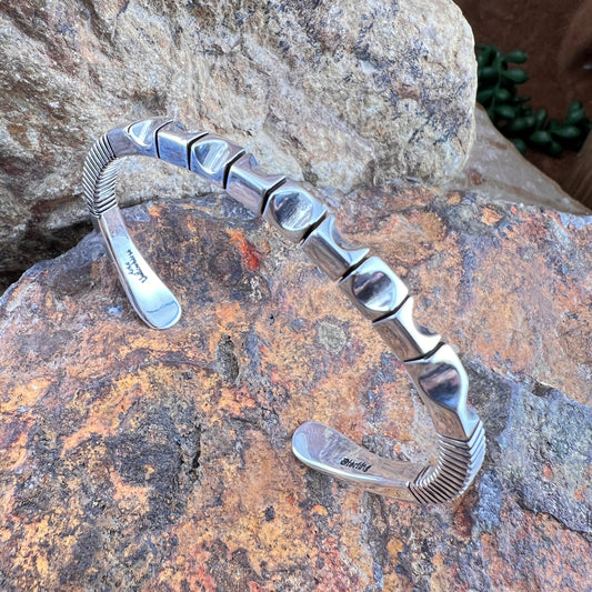 Silver bracelet on a textured stone surface
