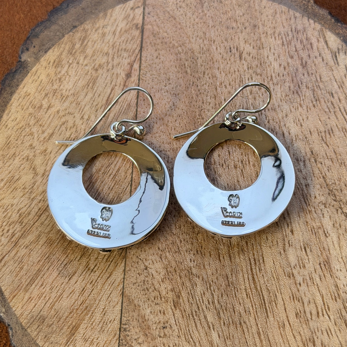 Sterling silver open-circle earrings with half-beaded detailing and cross accents, front view