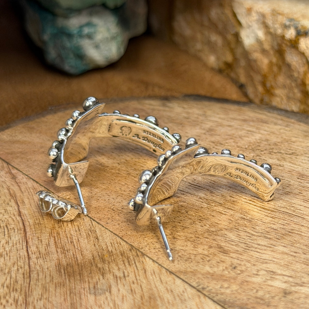 Back of A. Douglas sterling silver cross earrings showing hallmark and posts