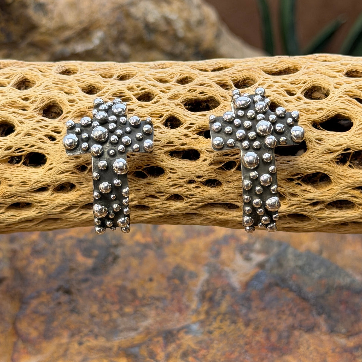 A. Douglas silver crosses with raised beadwork