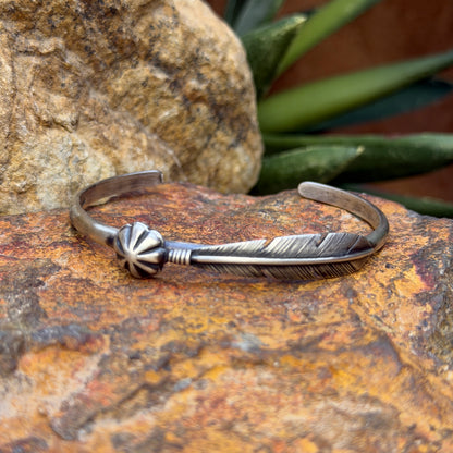 Ray Coriz sterling silver feather cuff showing raised feather shaft and scalloped concho