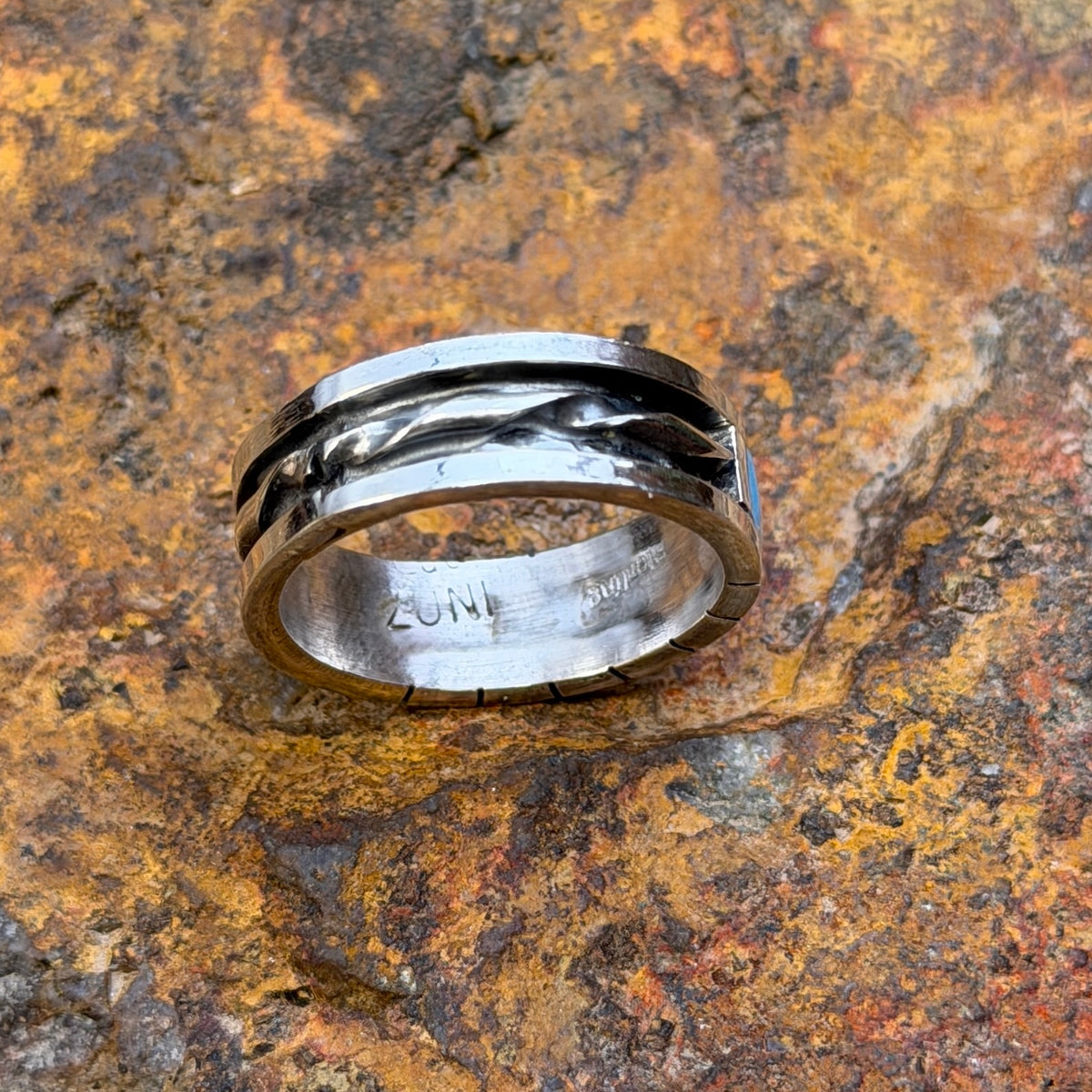 Back of band showing twisted-wire silverwork and interior stamps