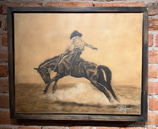 Framed artwork of a person riding a horse on a textured background, displayed against a brick wall.