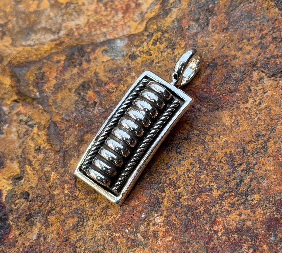Close-up of raised silver bars against darkened recesses