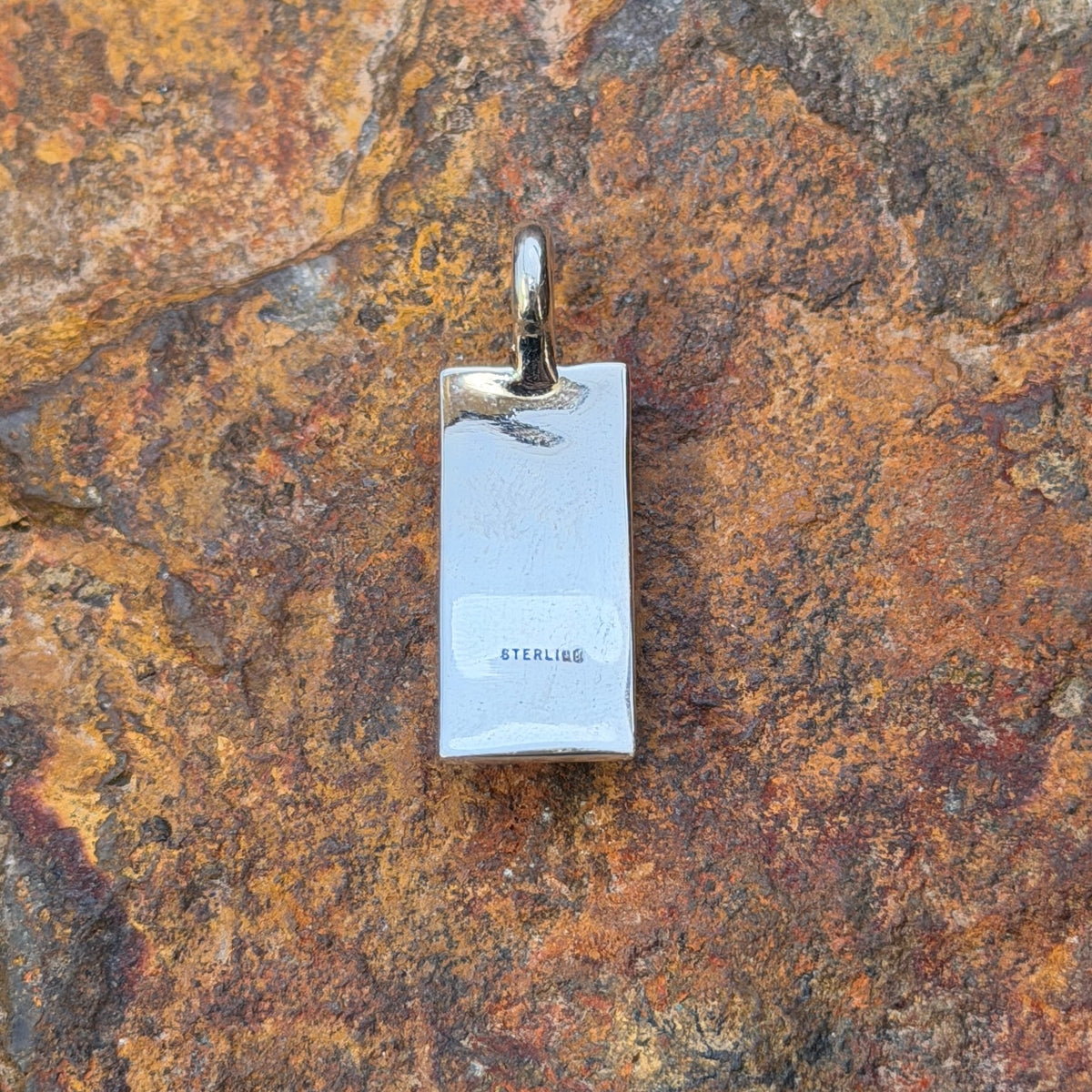 Back of Tom Charlie pendant stamped STERLING