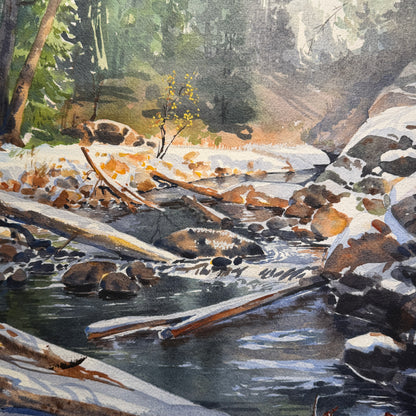 Winter scene with a stream, logs, and snow-covered ground.