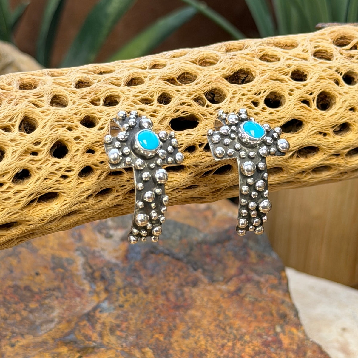 Silver beadwork and round turquoise cabochons on A. Douglas crosses