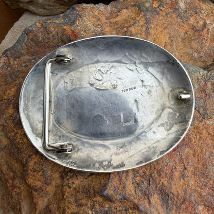  back of a Metal buckle on a textured stone surface