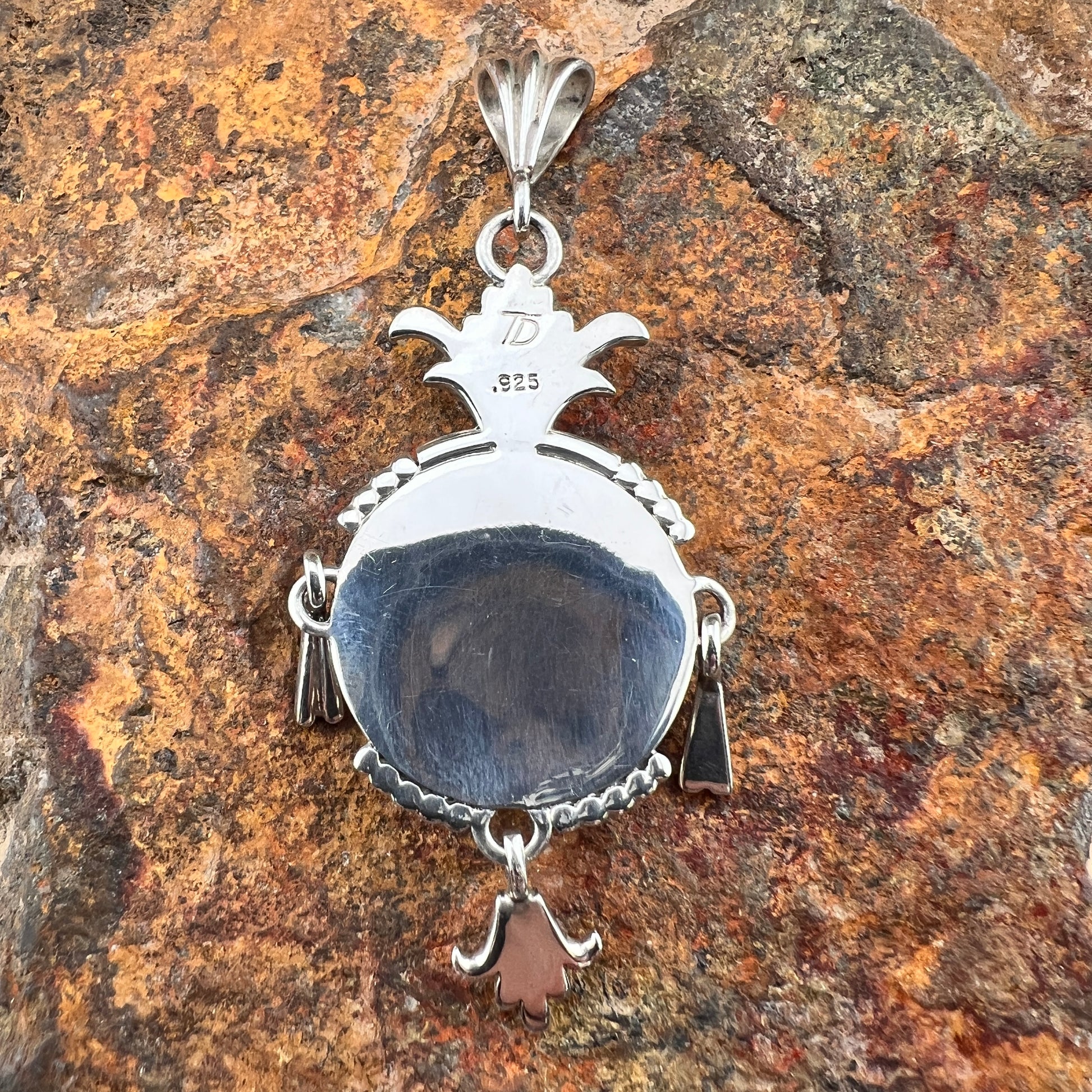 The back to the sterling silver Yei pendant. It is Hallmarked by Tracy Ray's stamp TP. It is also stamped ".925"
