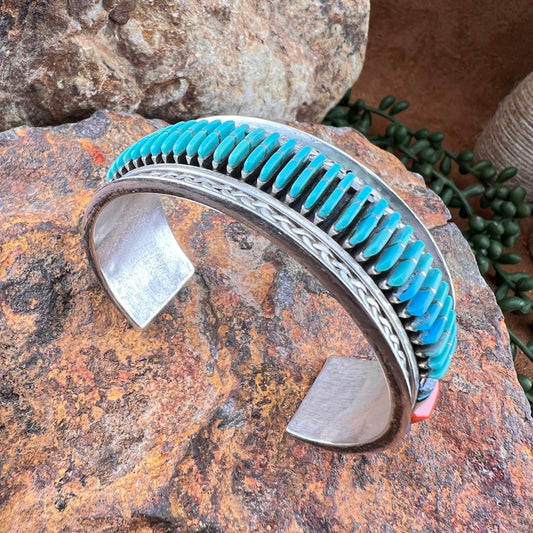 Silver and turquoise bracelet on a textured stone surface