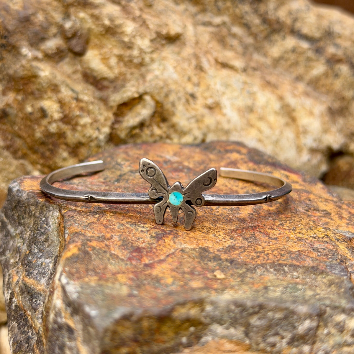 Vintage sterling silver butterfly cuff bracelet with blue turquoise center, front view
