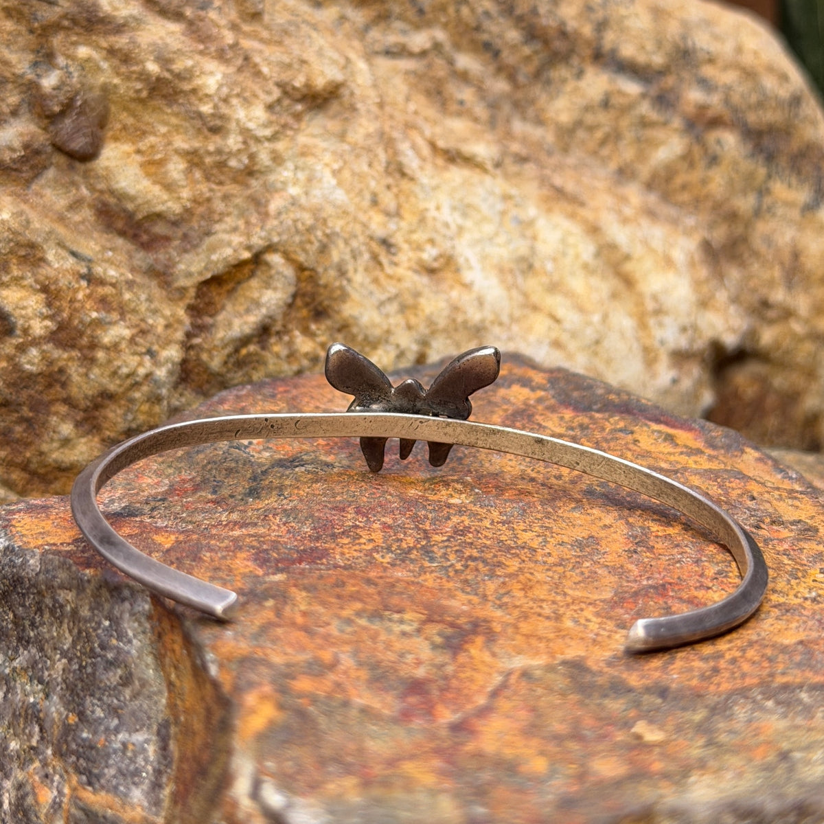 Angled view of vintage sterling silver turquoise butterfly cuff bracelet