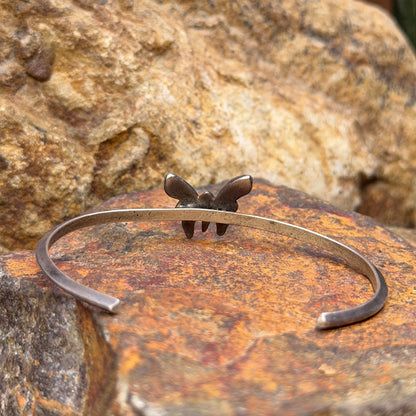 Angled view of vintage sterling silver turquoise butterfly cuff bracelet