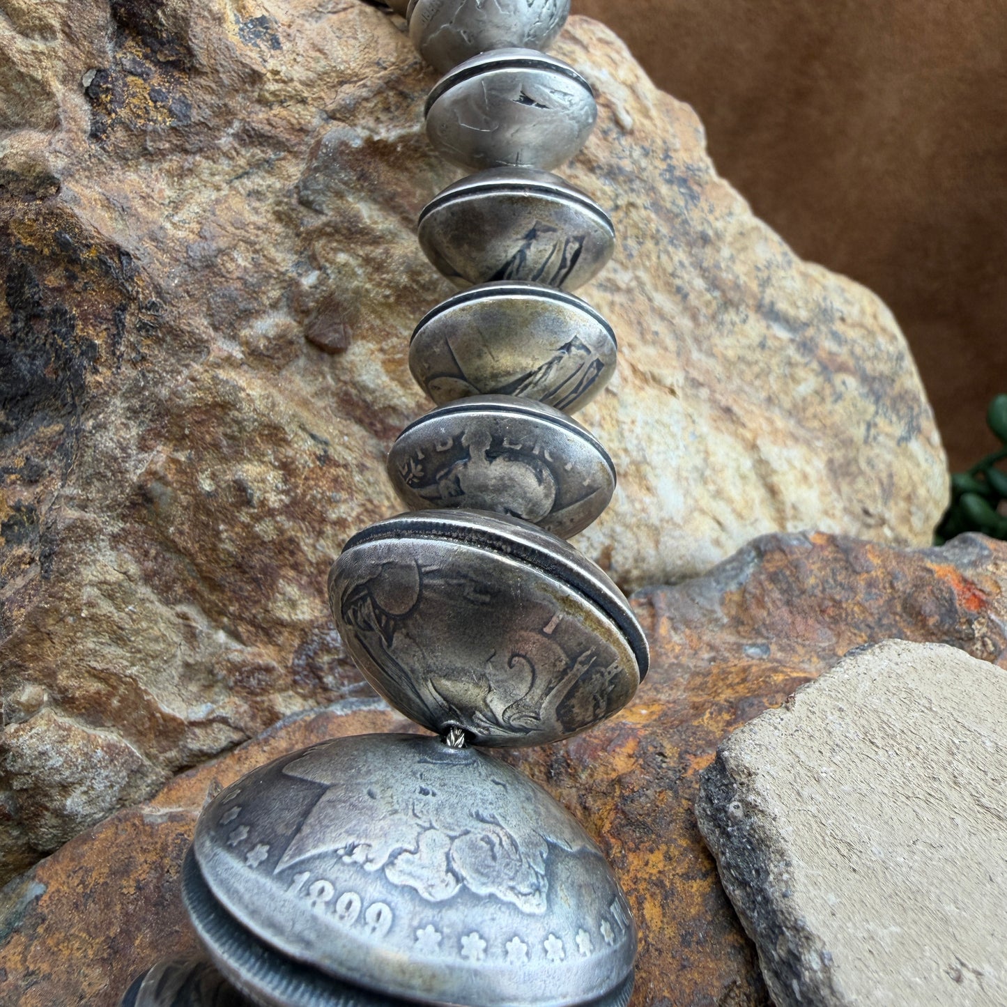 Necklace made of coins on a rocky surface