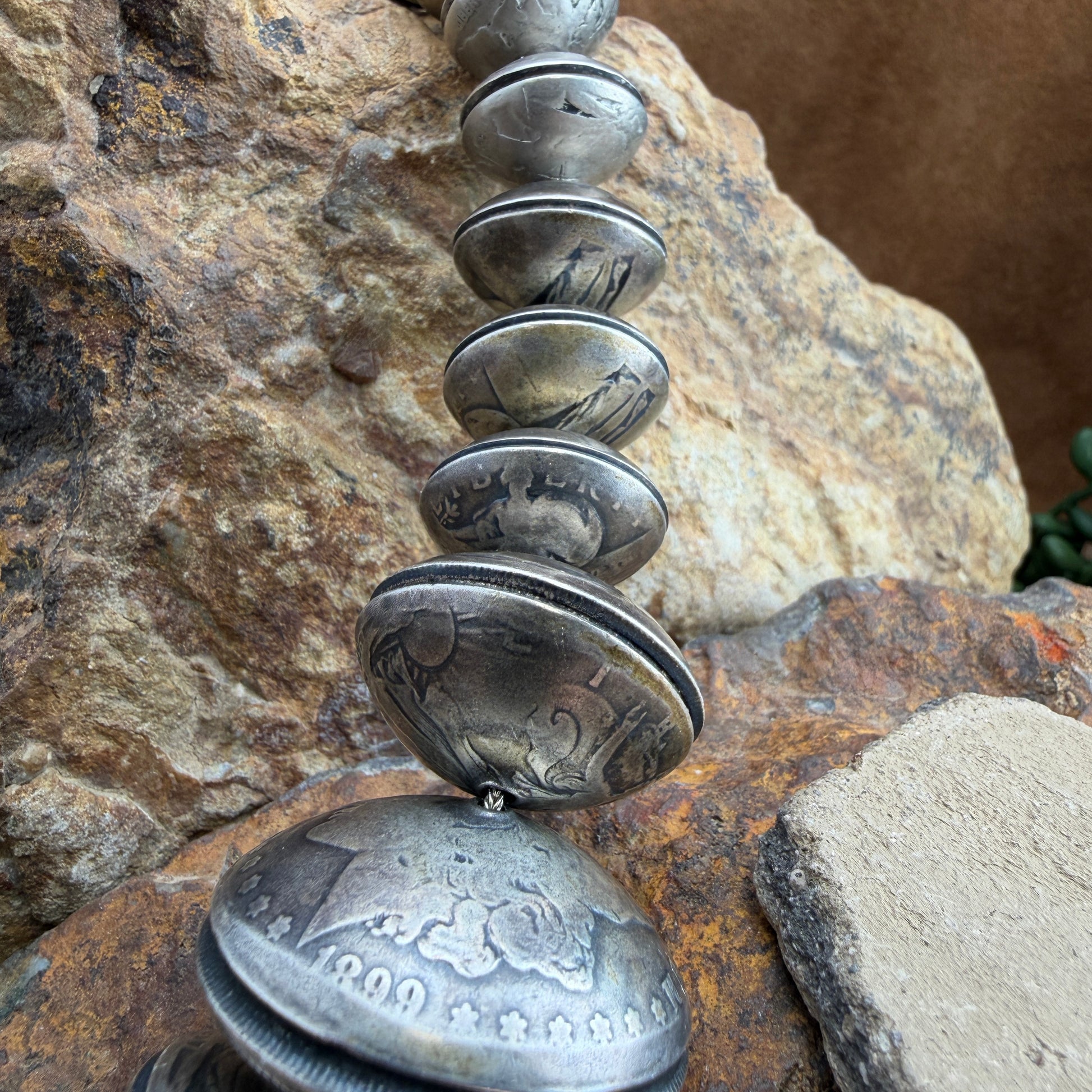 Necklace made of coins on a rocky surface