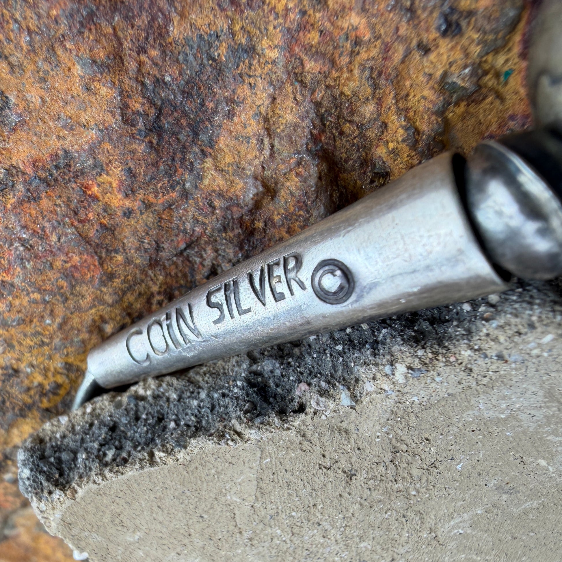 Conical end to a necklace stamped "Coin Silver"