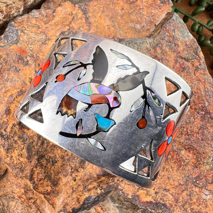 Decorative metal piece with colorful inlay on a stone surface