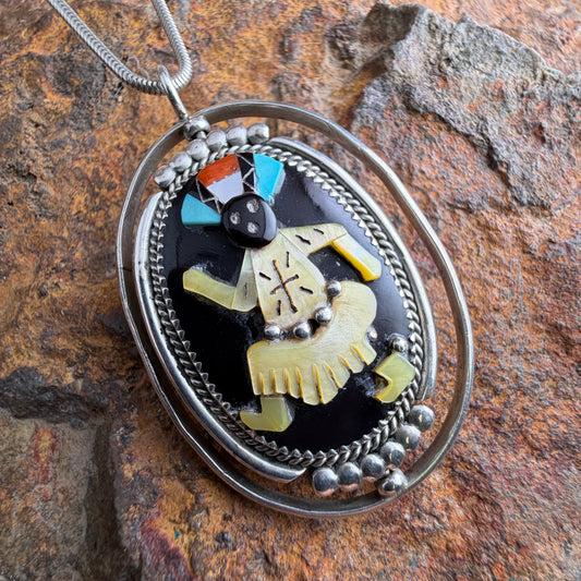 Pendant with a decorative design on a textured stone surface