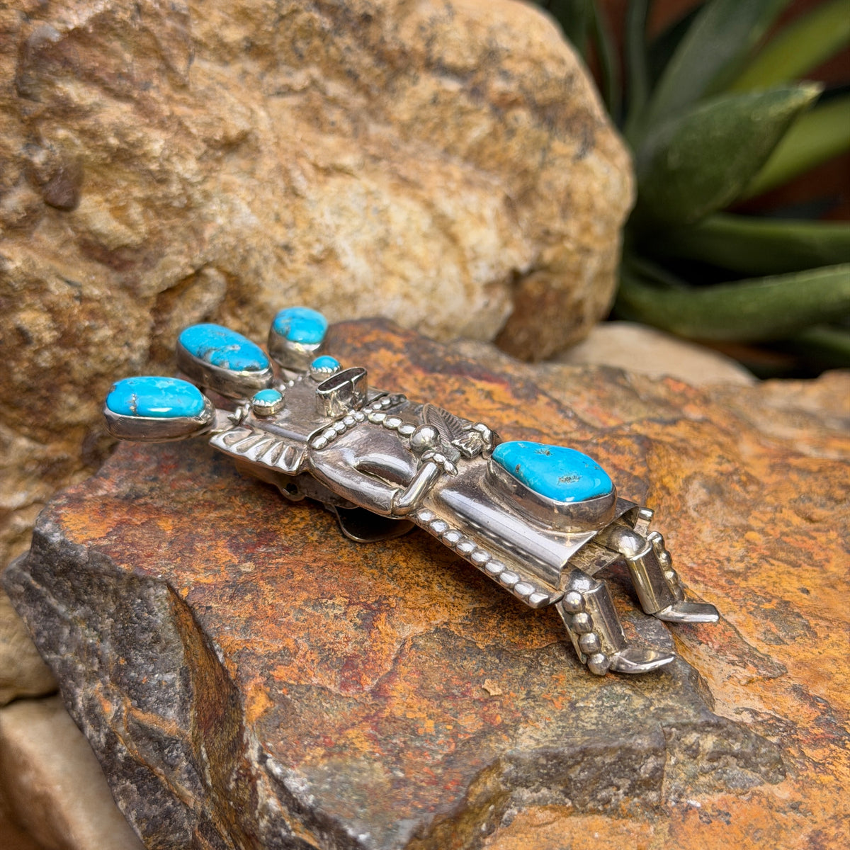 Angled view of vintage blue turquoise kachina bolo slide and pendant