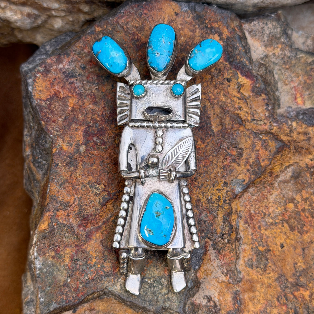 Detailed front view of blue turquoise kachina bolo slide and pendant