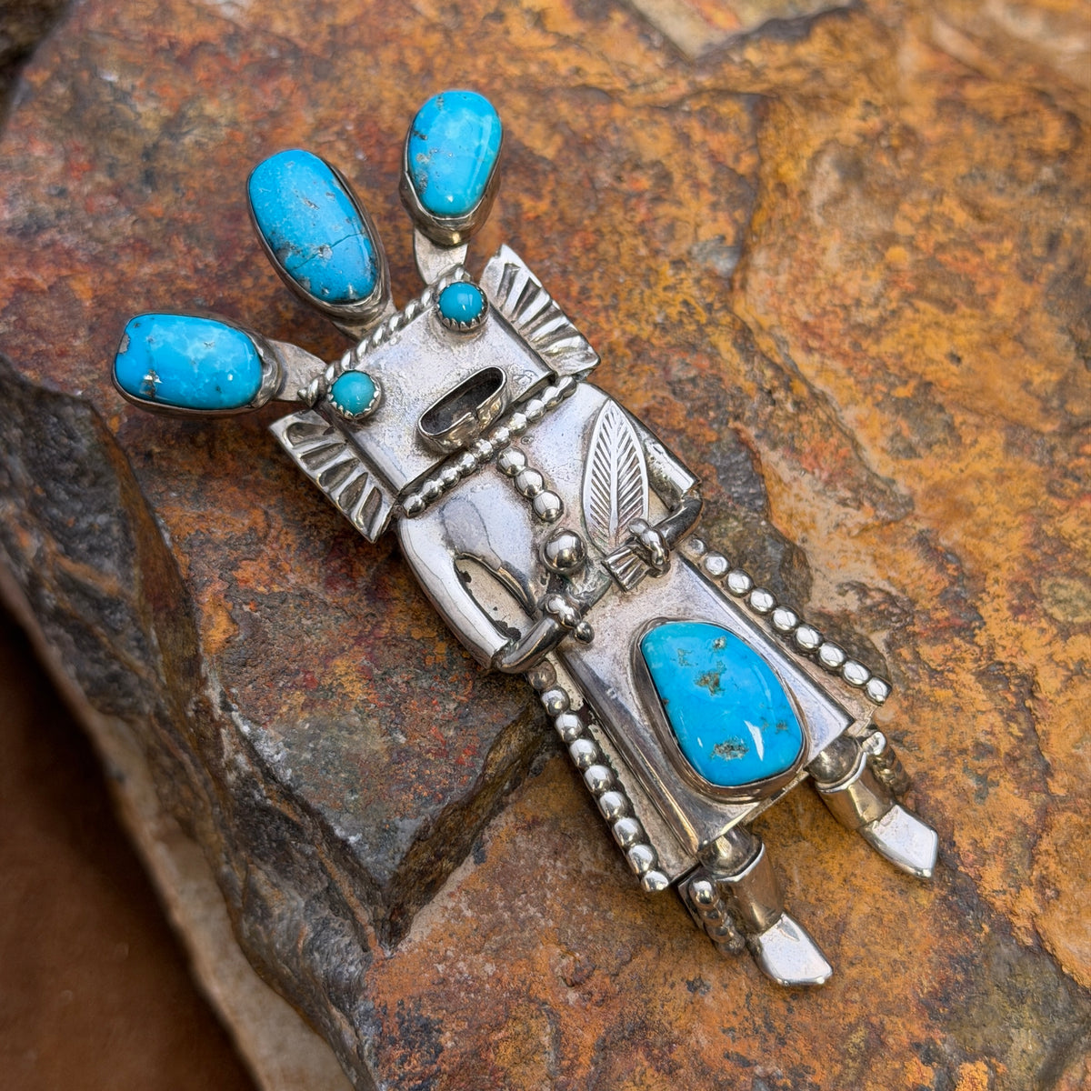 Full front view of kachina bolo slide and pendant with rich blue turquoise and crack in top center stone
