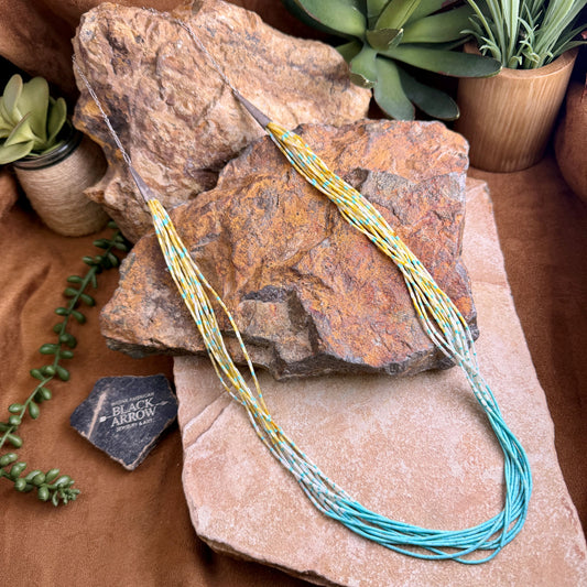 Colorful string or cord on a rock with plants in the background