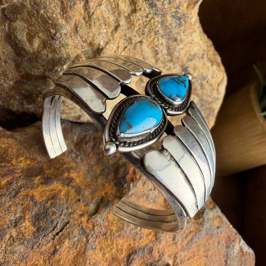 Silver bracelet with turquoise stones on a stone background