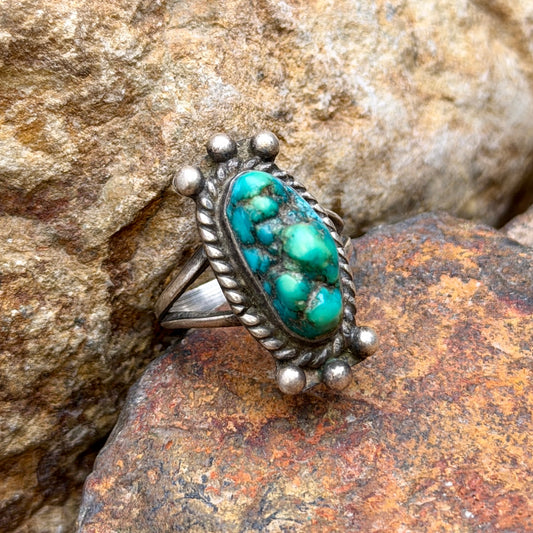 Side view of vintage turquoise ring showing bezel setting and split shank