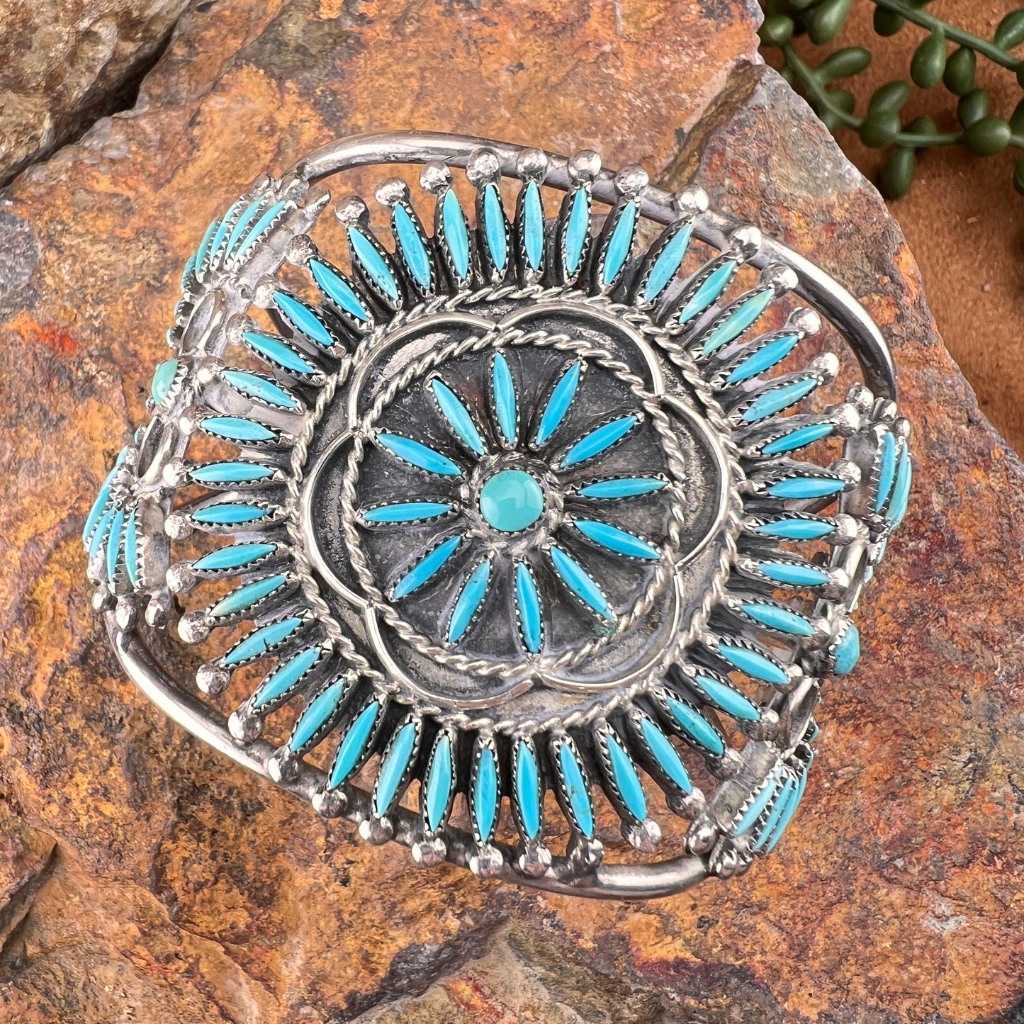 Silver and turquoise bracelet on a stone surface