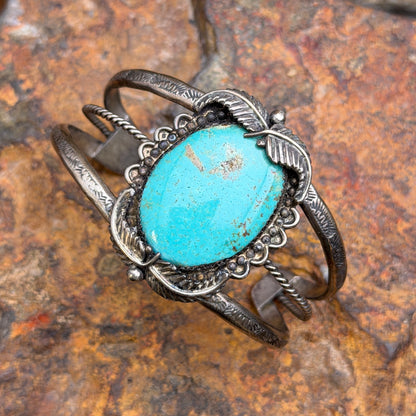 Front view of vintage sterling silver turquoise cuff with silver leaf details and RECO hallmark