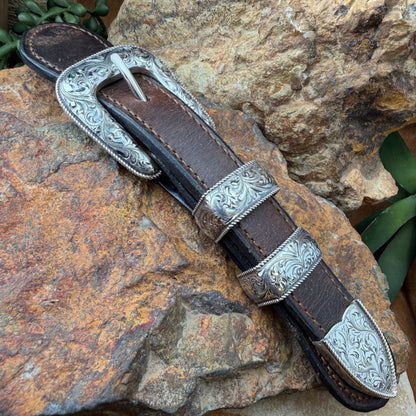 Decorative belt with leather sheath on a rocky surface