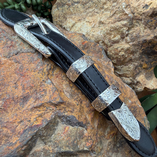Decorative belt buckle with silver on a rocky surface