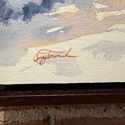 Artistic signature on a textured surface with a blurred background