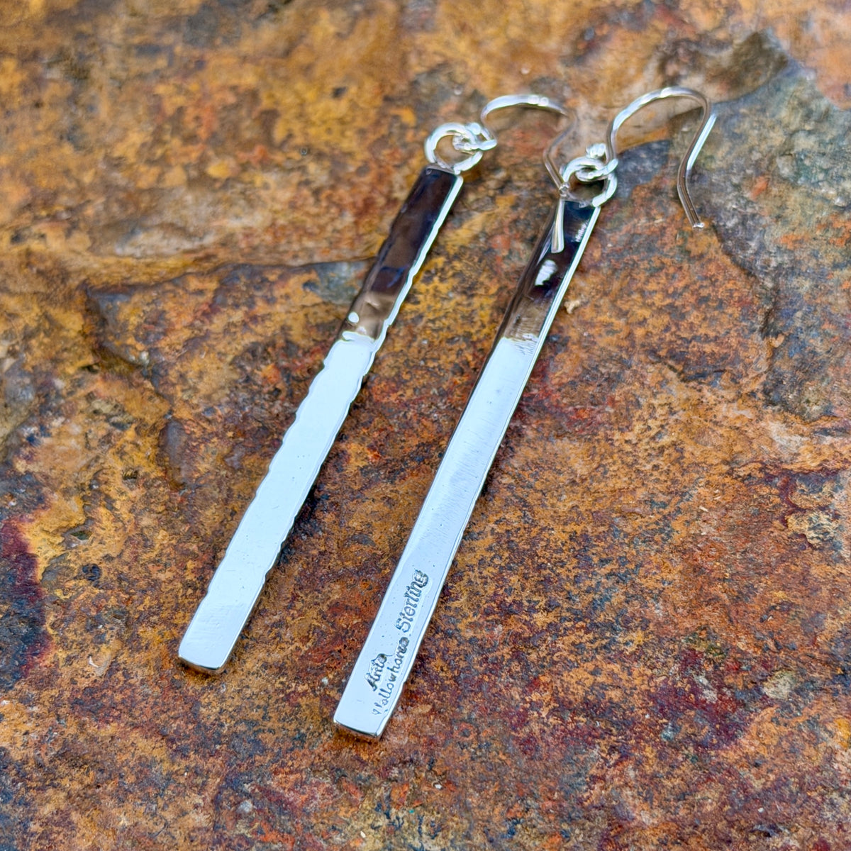 elongated rectangle earrings with diagonal geometric line pattern by artie yellowhorse displaying hallmark side