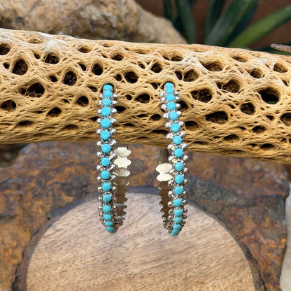 Sleeping Beauty turquoise hoop earrings by Marlon Quam, angled view