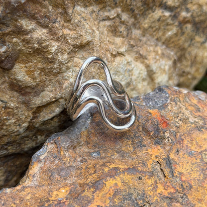 Front view of Ray Coriz smooth wave ring showing its three flowing silver bands