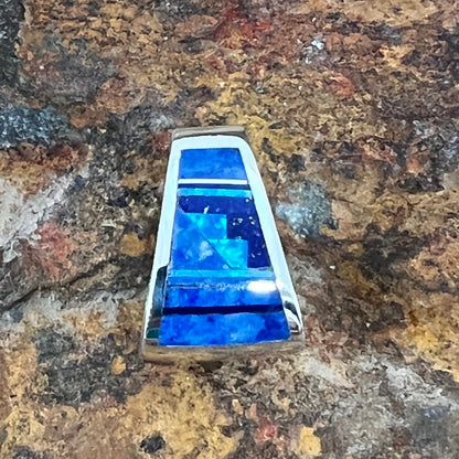 as part of the Blue Sky Collection, features Royal Lapis, Denim Lapis and Cultured Opal in a Fancy Inlaid Pattern