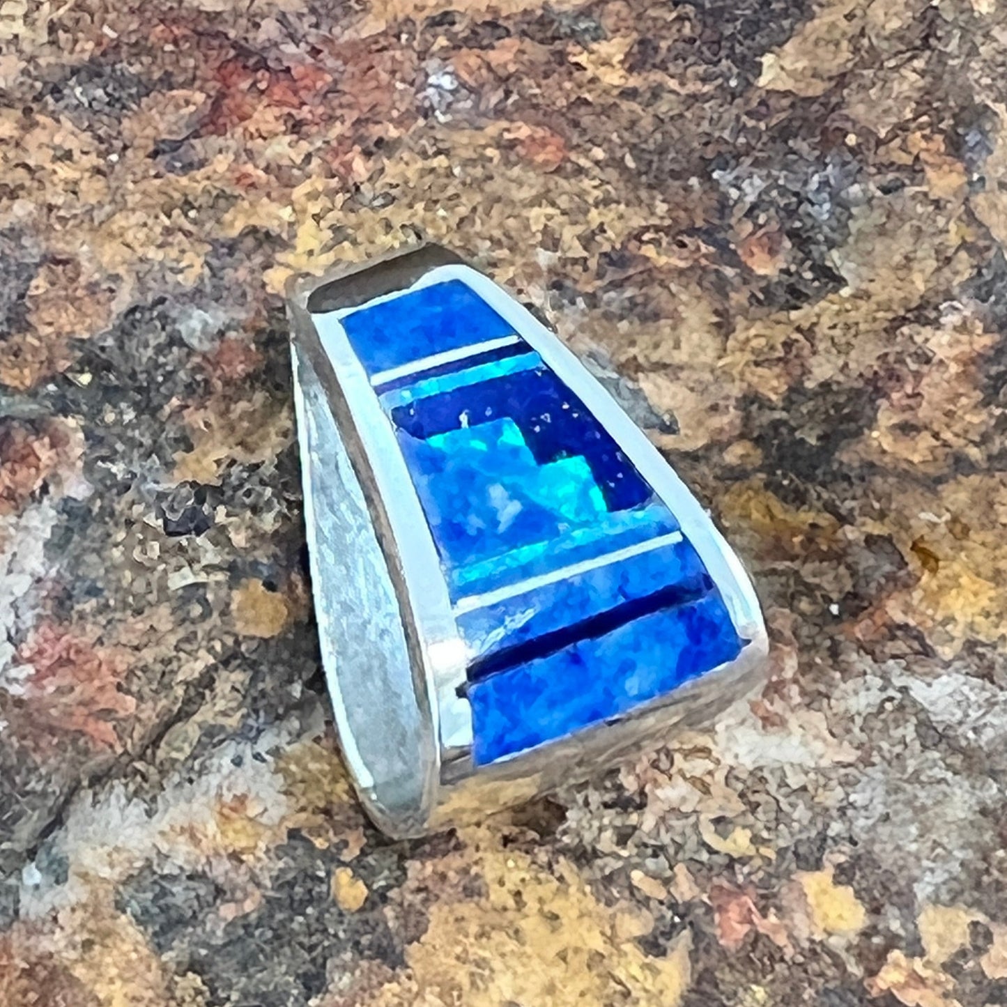 as part of the Blue Sky Collection, features Royal Lapis, Denim Lapis and Cultured Opal in a Fancy Inlaid Pattern
